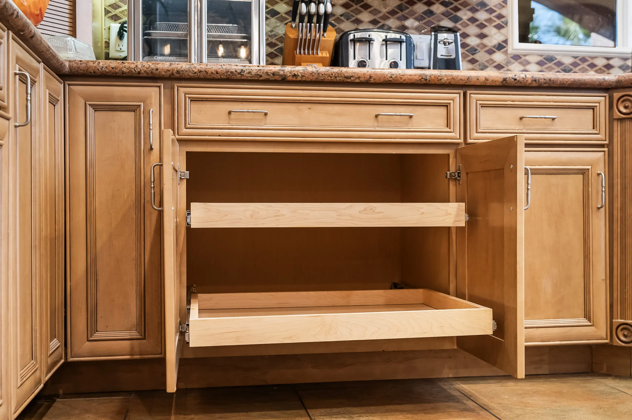 Open kitchen cabinet with pull-out shelves