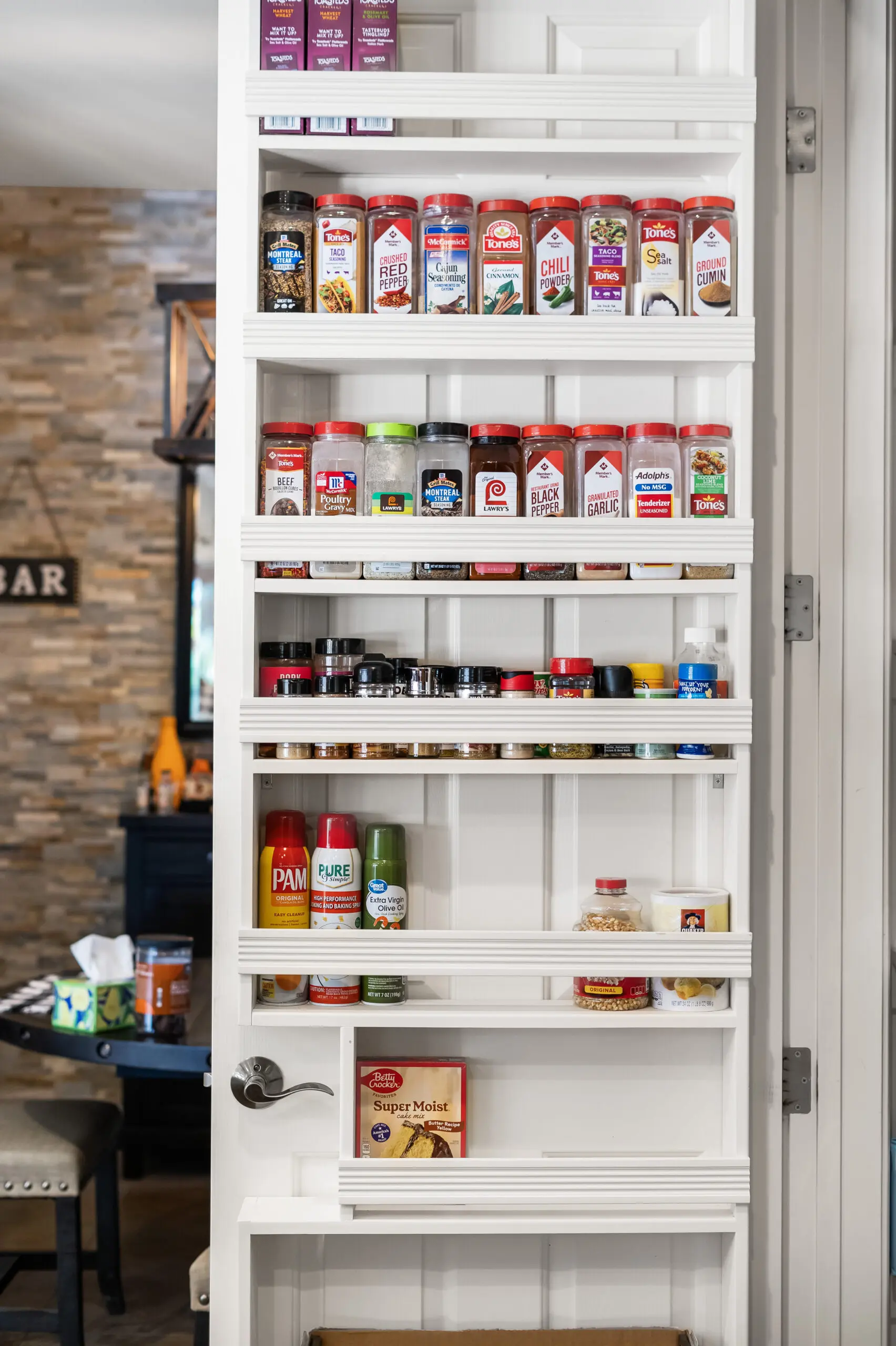 Assorted spices on white shelves