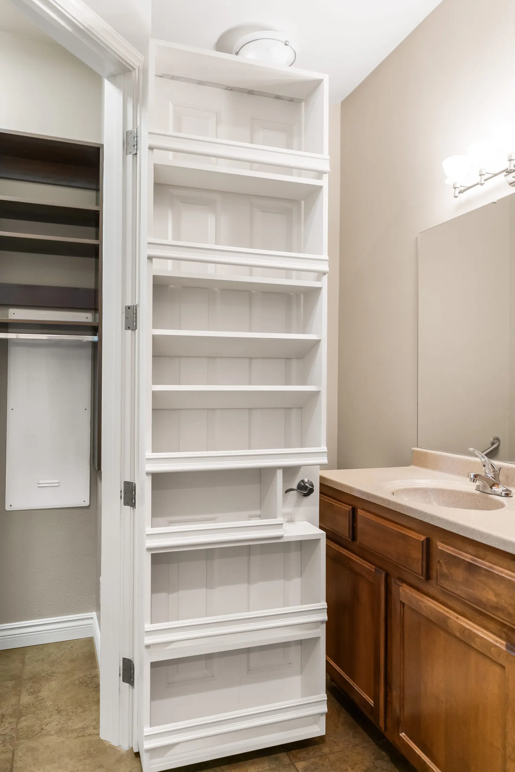 Bathroom storage shelves next to sink