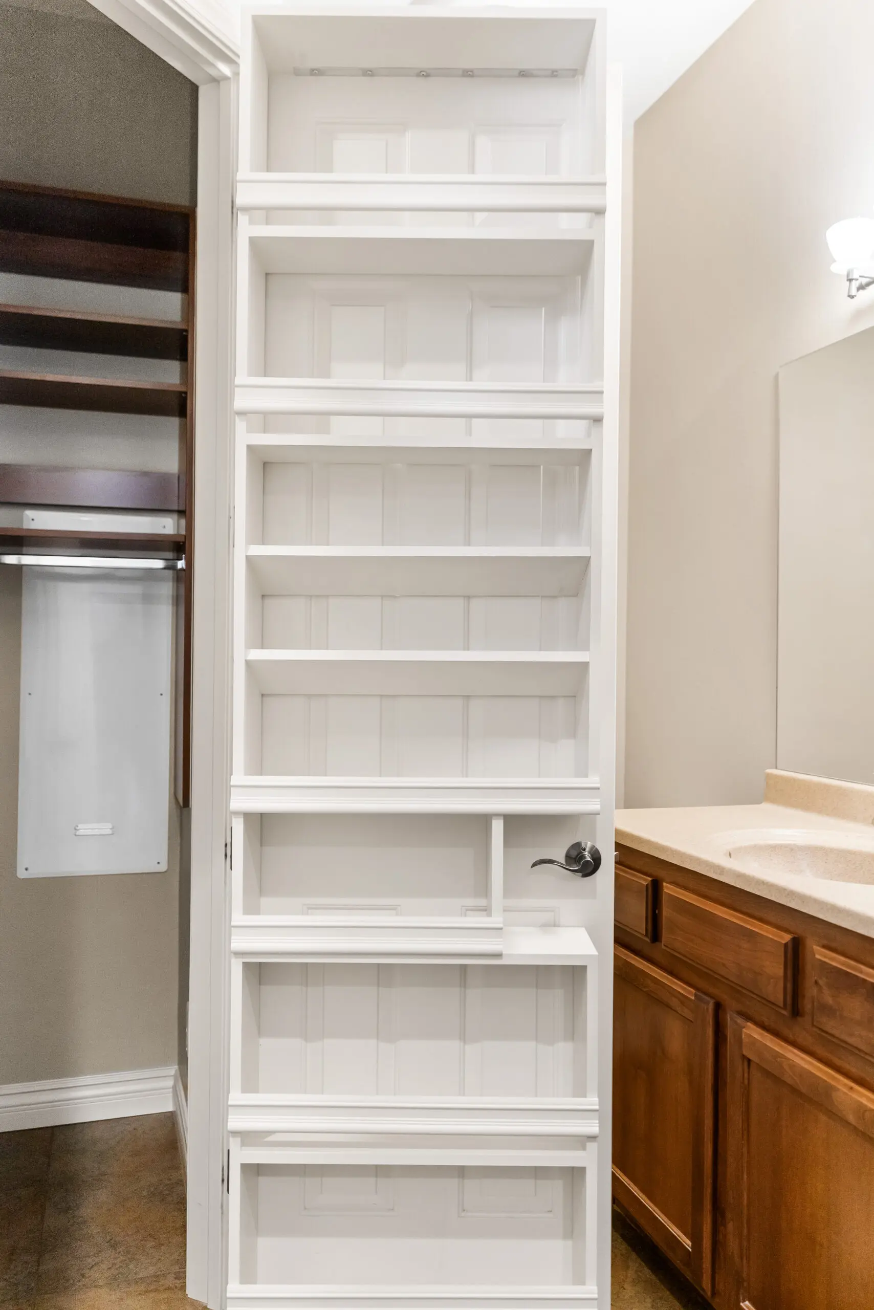 Bathroom storage shelves with closed door